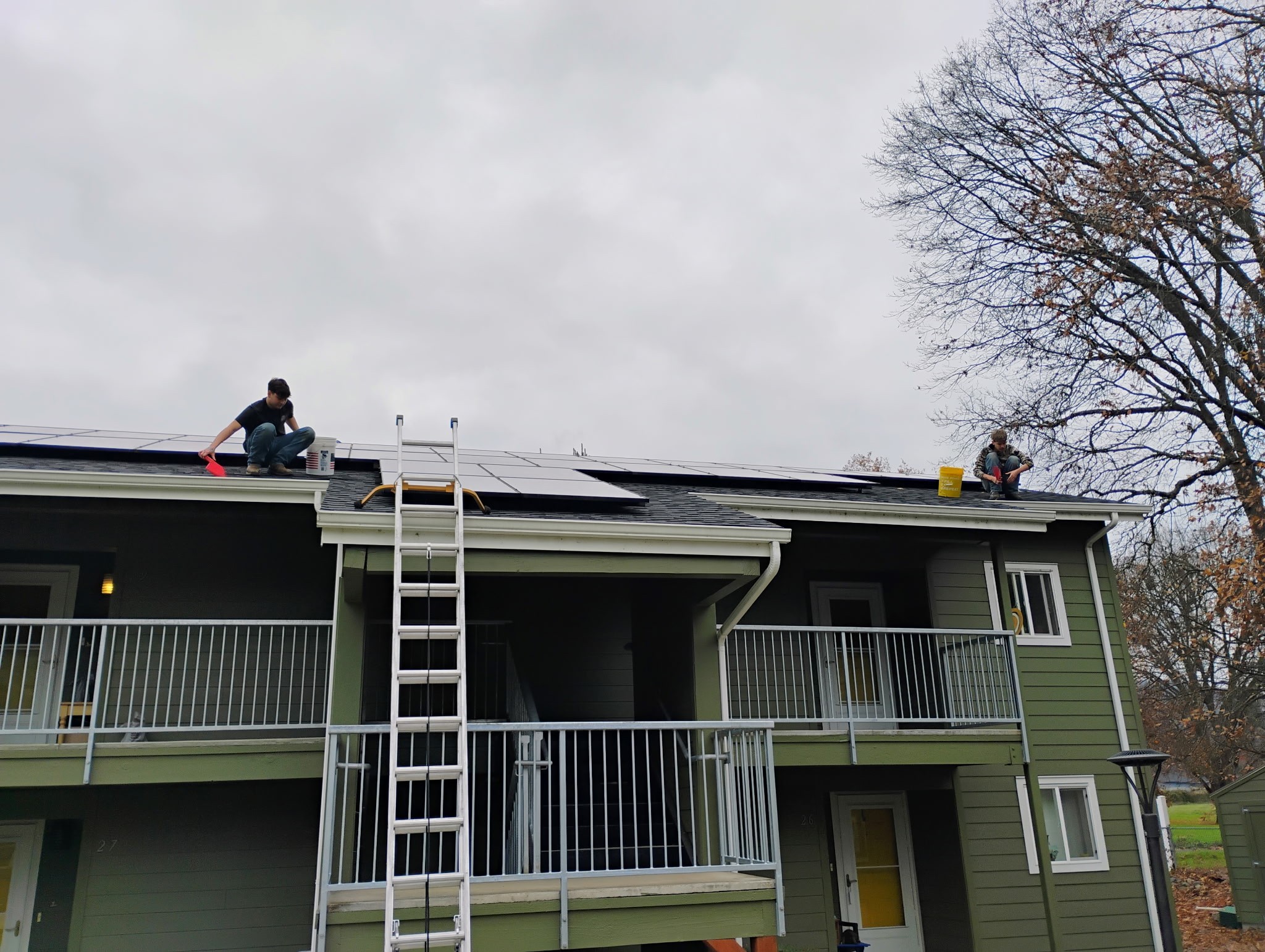 Team working on a roof near installed solar panels